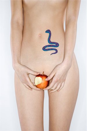 sin - Portrait of nude attractive redhead Caucasian young woman with snake tattoo holding apple. Stock Photo - Budget Royalty-Free & Subscription, Code: 400-04955766