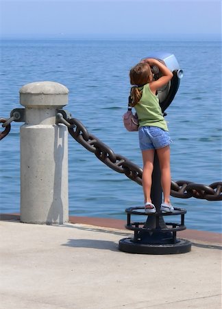 person focusing telescope - An little girl on an telescope looking over the lake Ontario on the lake  promenade in Burlington. Stock Photo - Budget Royalty-Free & Subscription, Code: 400-04956167