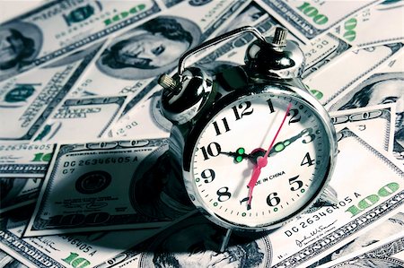 racnus (artist) - An alarm clock over a hundred dollar bill. Fotografie stock - Microstock e Abbonamento, Codice: 400-04956163