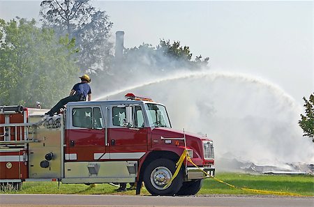 fire truck close - Fireman At Work Putting out the Last of a Fire Stock Photo - Budget Royalty-Free & Subscription, Code: 400-04956234