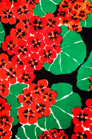 Close-up of vintage fabric with vibrant red geraniums and green leaves printed on polyester. Stockbilder - Microstock & Abonnement, Bildnummer: 400-04956267