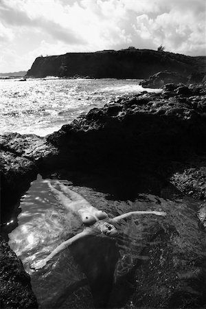 simsearch:400-04955255,k - Young nude Asian woman floating in water with arms outstretched in Maui, Hawaii. Stockbilder - Microstock & Abonnement, Bildnummer: 400-04956607