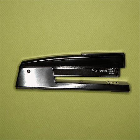 simsearch:400-03926032,k - Black stapler on green background. Stock Photo - Budget Royalty-Free & Subscription, Code: 400-04956917