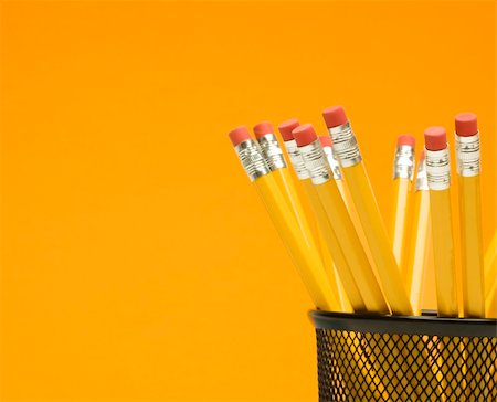 simsearch:400-04451935,k - Group of pencils in pencil holder on orange background. Fotografie stock - Microstock e Abbonamento, Codice: 400-04956969