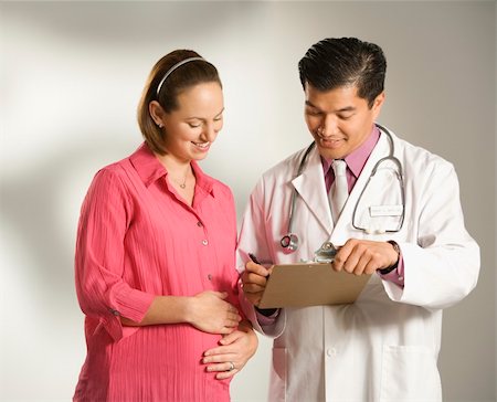 prenatal asian - Asian American male doctor consulting with pregnant Caucasian woman. Stock Photo - Budget Royalty-Free & Subscription, Code: 400-04957098