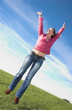 simsearch:400-04450996,k - Young woman in casual dress leaps in the air with joy! Stock Photo - Budget Royalty-Free & Subscription, Code: 400-04957542