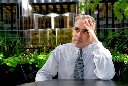 simsearch:400-04345508,k - Businessman sitting in outdoor cafe frustrated Stock Photo - Budget Royalty-Free & Subscription, Code: 400-04957720