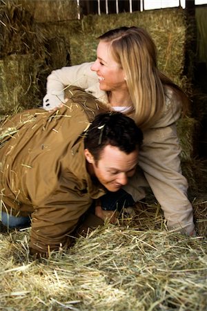 Mid-adult Caucasian couple wrestling in hay. Stock Photo - Budget Royalty-Free & Subscription, Code: 400-04957760
