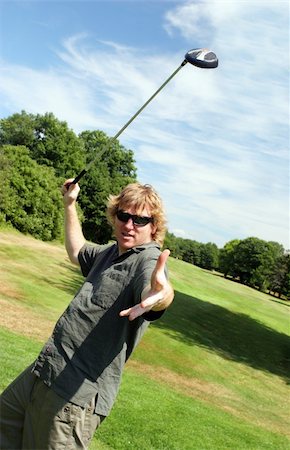 Man swinging a golf club Stock Photo - Budget Royalty-Free & Subscription, Code: 400-04957898