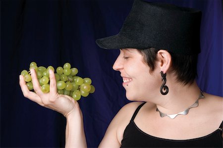 photo of model woman with grapes - Thirty something model eating green grapes Stock Photo - Budget Royalty-Free & Subscription, Code: 400-04957957