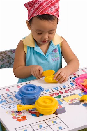 plastic toy family - A pretty little girl playing with plastic toys Stock Photo - Budget Royalty-Free & Subscription, Code: 400-04958247