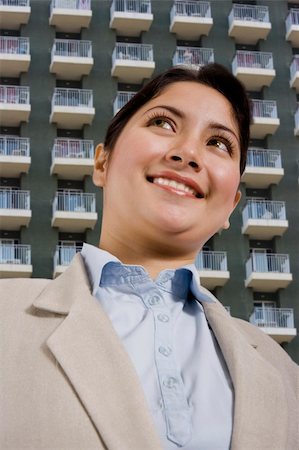 beautiful young woman standing in front of a hotel or apartments. Stock Photo - Budget Royalty-Free & Subscription, Code: 400-04958242