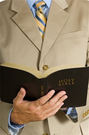 Man in business suit or preacher holding the BIble Stock Photo - Budget Royalty-Free & Subscription, Code: 400-04958667