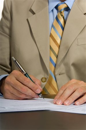 Business man in suit signing a contract or document Stock Photo - Budget Royalty-Free & Subscription, Code: 400-04958668