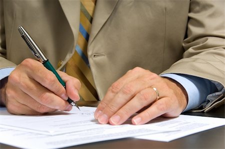 Business man in suit signing a contract or document Stock Photo - Budget Royalty-Free & Subscription, Code: 400-04958669