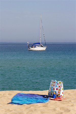 beach towel and bag with yacht in background, corsica, france, mediterranean Stock Photo - Budget Royalty-Free & Subscription, Code: 400-04959685