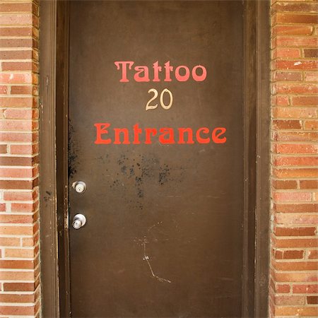 Doorway entrance to tattoo parlor. Stockbilder - Microstock & Abonnement, Bildnummer: 400-04950325