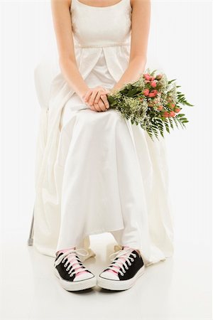 simsearch:400-04950359,k - Caucasian bride holding bouquet exposing her tennis shoes. Stock Photo - Budget Royalty-Free & Subscription, Code: 400-04950358