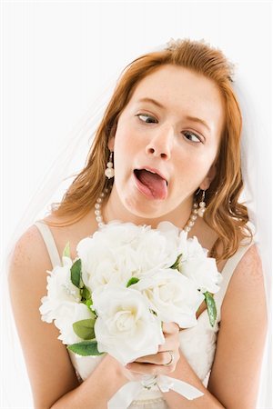 simsearch:400-04950359,k - Portrait of Caucasian bride holding bouquet and making funny face. Stock Photo - Budget Royalty-Free & Subscription, Code: 400-04950353