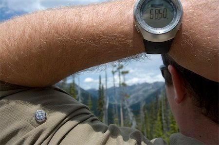 spartika (artist) - A man wears an altimeter that detects the altitude of a mountain lookout as 6,850 feet. Stock Photo - Budget Royalty-Free & Subscription, Code: 400-04950363