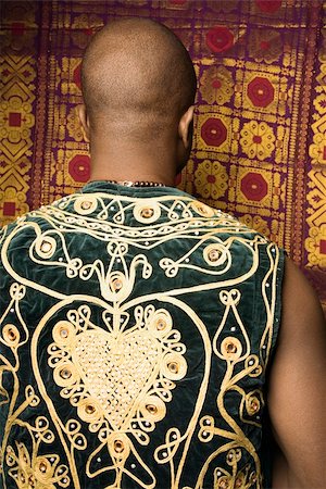 embroidery for male clothes - Rear view portrait of African-American mid-adult man wearing embroidered African vest. Photographie de stock - Aubaine LD & Abonnement, Code: 400-04950469
