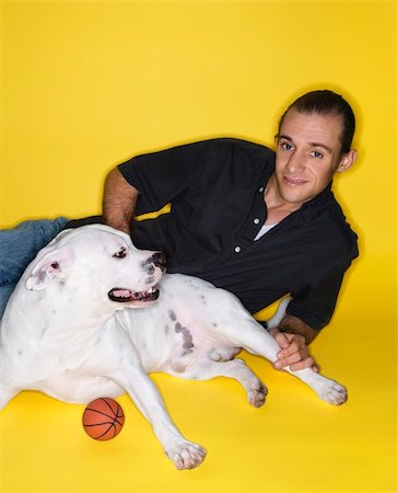 simsearch:400-04446275,k - Young adult male Caucasian lying with white  Pit Bull dog. Foto de stock - Super Valor sin royalties y Suscripción, Código: 400-04951180