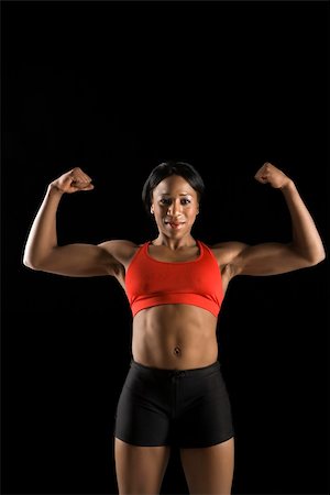 Muscular African American woman wearing athletic apparel with biceps flexed. Stock Photo - Budget Royalty-Free & Subscription, Code: 400-04951192