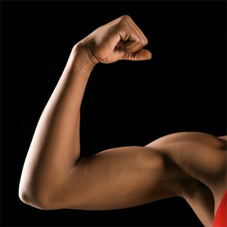 Arm of African American woman flexing muscular bicep. Stock Photo - Budget Royalty-Free & Subscription, Code: 400-04951193