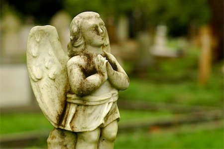 A very old little angel statue at cemetery Stock Photo - Budget Royalty-Free & Subscription, Code: 400-04951374