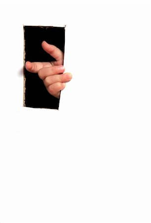 child fingers through black hole in white paper Stock Photo - Budget Royalty-Free & Subscription, Code: 400-04951709