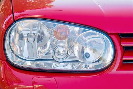 A close-up of the headlight of a red car Stockbilder - Microstock & Abonnement, Bildnummer: 400-04952070