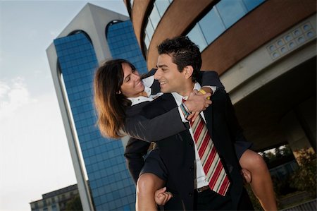 romantic carrying on shoulder - businesswoman riding piggyback on his colleague during a break from work Stock Photo - Budget Royalty-Free & Subscription, Code: 400-04952294