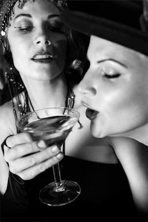 people drinking at a bar black and white images - Caucasian prime adult retro female taking drink of girl friend's martini. Stock Photo - Budget Royalty-Free & Subscription, Code: 400-04952652