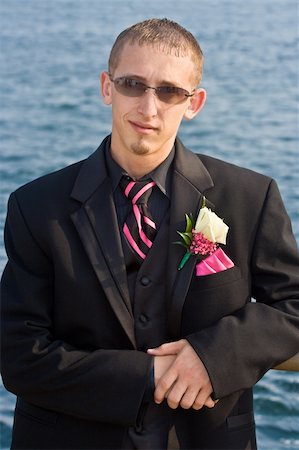 Portrait of a teenage boy in a tuxedo. Background is a blue ocean. The teen is dressed for a high school prom but the photo could be used to represent any formal occasion. Foto de stock - Super Valor sin royalties y Suscripción, Código: 400-04952695