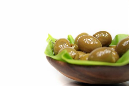 simsearch:400-07219392,k - A few olives in a bowl of lumber on a green leaf Stock Photo - Budget Royalty-Free & Subscription, Code: 400-04952899
