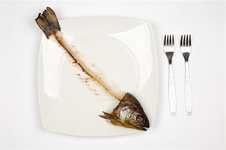 fish bones on plate - eaten fish with head and tail - symbol of misery Stock Photo - Budget Royalty-Free & Subscription, Code: 400-04953173