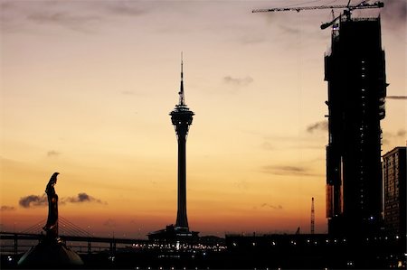 The sunset composition with Kun Iam statue, tower convention, and a under construction casion Stock Photo - Budget Royalty-Free & Subscription, Code: 400-04953412
