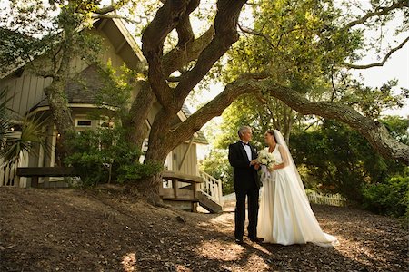 simsearch:400-04950359,k - Mid-adult bride and groom standing outside of church. Stock Photo - Budget Royalty-Free & Subscription, Code: 400-04953701