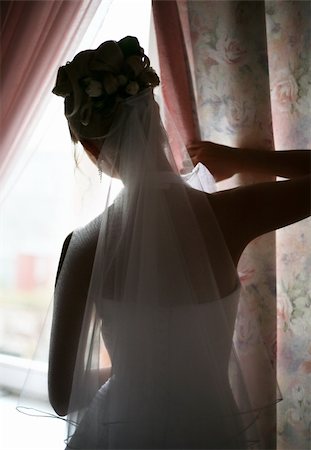 The beautiful bride prepares for wedding. Silhouette on a background of a window Stock Photo - Budget Royalty-Free & Subscription, Code: 400-04964343