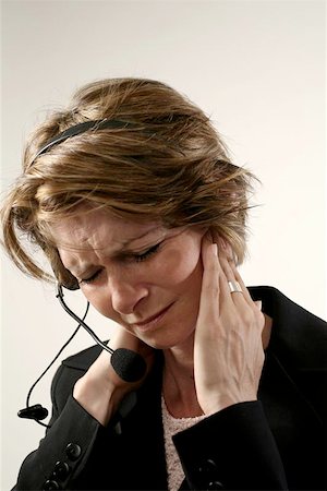 phone with pain - receptionist with headache Stock Photo - Budget Royalty-Free & Subscription, Code: 400-04965295