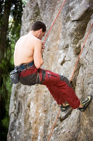 simsearch:400-03936239,k - A male climber repells down a rock face - crag. Stockbilder - Microstock & Abonnement, Bildnummer: 400-04966376