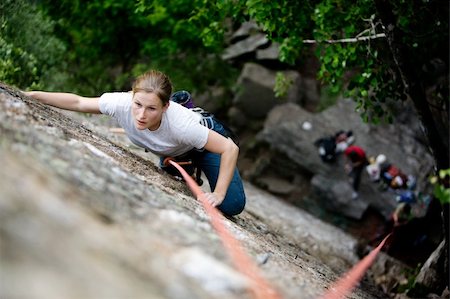 simsearch:400-03936239,k - A female climber on a steep rock face.  Shallow depth of field is used to isolated the climber.  Focus is on the head, shoulders and arms of the climber. Stockbilder - Microstock & Abonnement, Bildnummer: 400-04966377