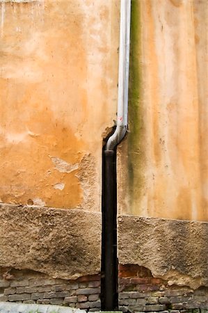Drain pipe and aged wall surface texture image.  Taken in the old town area of Prague, Czech Republic.  A moody surface with film grain. Stock Photo - Budget Royalty-Free & Subscription, Code: 400-04966530