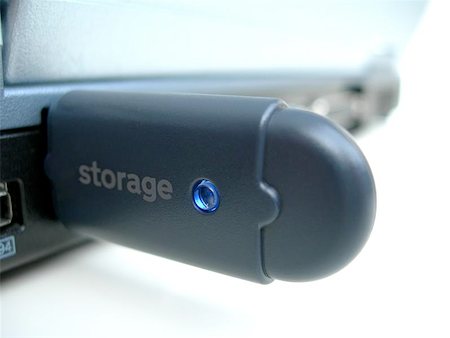 A USB Storage stick attached to the back of a laptop. Stock Photo - Budget Royalty-Free & Subscription, Code: 400-04967218