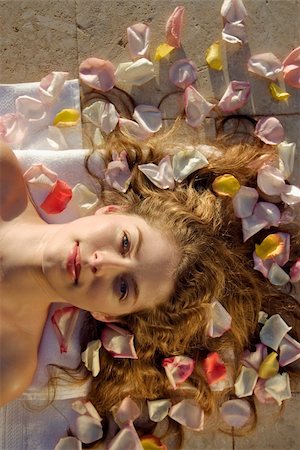 someone laying down aerial view - Above view of bare Caucasian mid-adult woman lying down with hair spread out on rose petals. Stock Photo - Budget Royalty-Free & Subscription, Code: 400-04967432