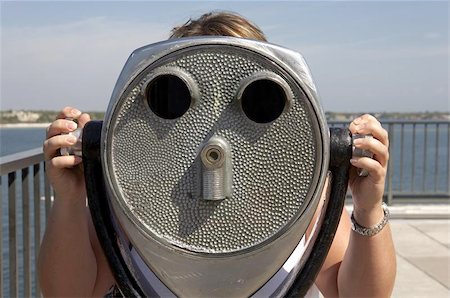 Woman looking through a coin operated binoculars on the top of the pier st Petersburg, florida united state usa taken in march 2006 Stock Photo - Budget Royalty-Free & Subscription, Code: 400-04967601