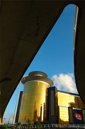 Sunlight reflecting off of the round, golden mirrored tower of the Sands Macau Casino and Hotel taken from under the overpass, Macau Stock Photo - Budget Royalty-Free & Subscription, Code: 400-04968041