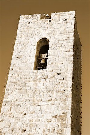 Tower with a clock in Antibes, France.  Sepia tone. Foto de stock - Super Valor sin royalties y Suscripción, Código: 400-04968392