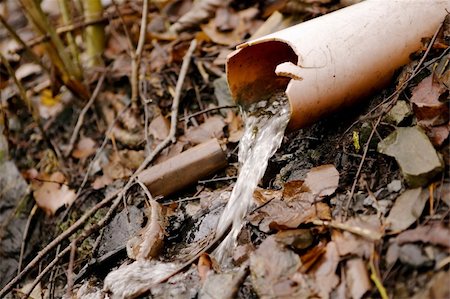 running off - A water pipe coming out of the ground pouing out into nature. Stock Photo - Budget Royalty-Free & Subscription, Code: 400-04968476
