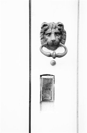 door lion - Knocker in the form of a lion's head on a door in Antibes, France.  Copy space. Stock Photo - Budget Royalty-Free & Subscription, Code: 400-04968582